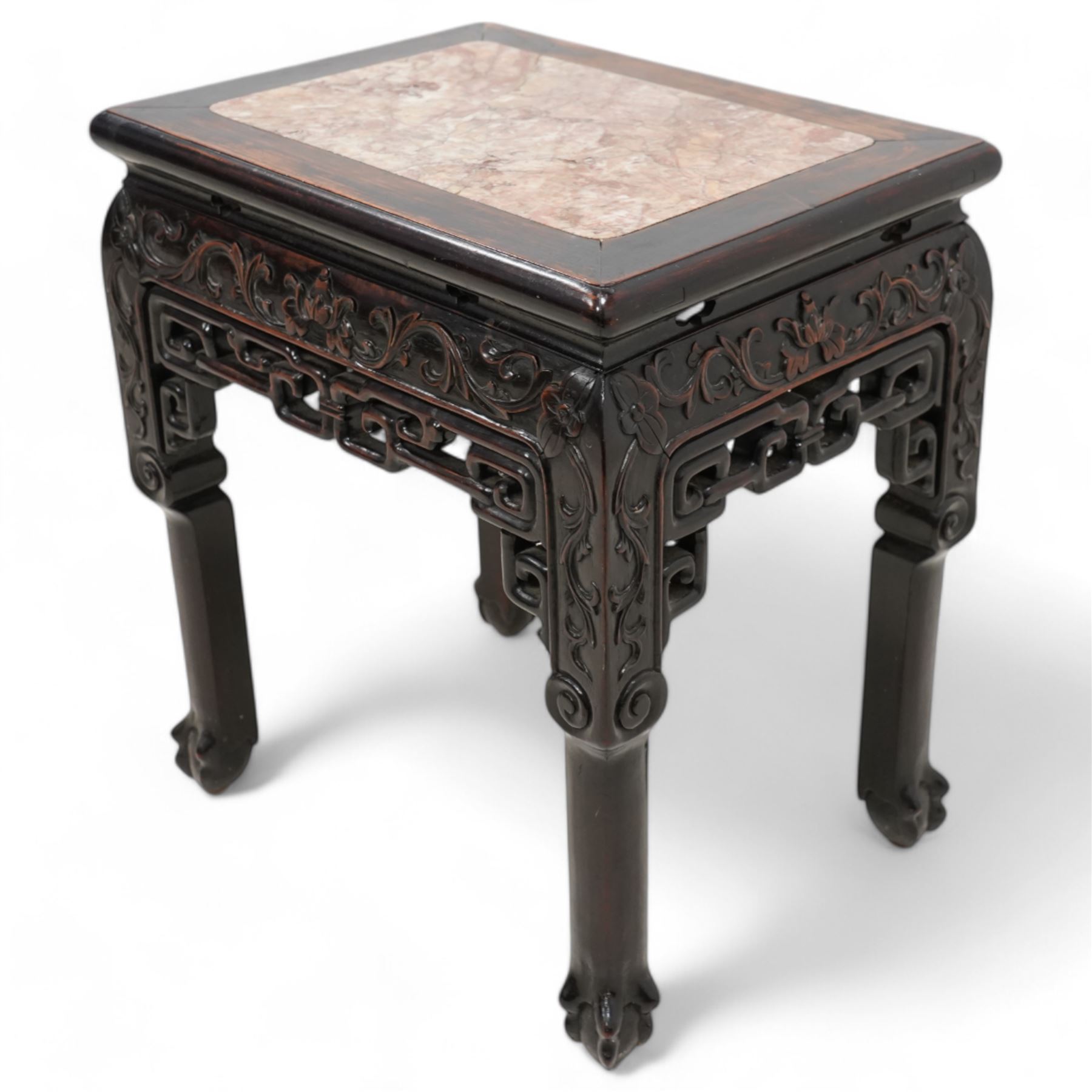 Early 20th century Chinese carved hardwood and marble urn stand, rectangular moulded top with inset variegated rouge marble, carved with curling leafy branches and scrolls, shaped and pierced brackets, on ball and claw carved supports 