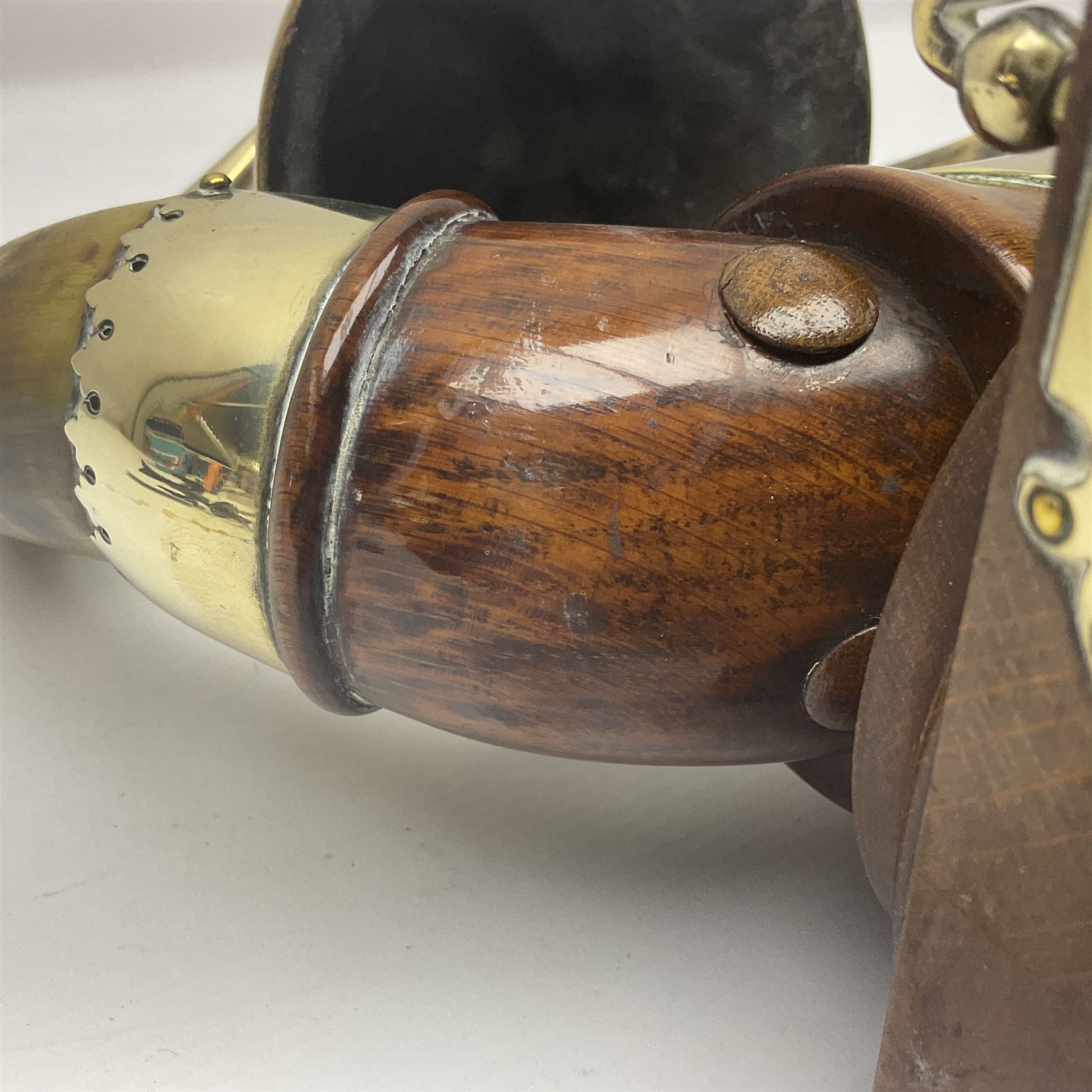 Early 20th century oak and horn dinner bell, the silvered bell suspended from a pair of cow horns, with silver plated mounts and blank shield shaped cartouche, upon square base, H37cm