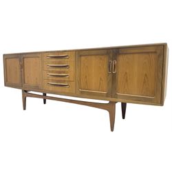 G-Plan – teak sideboard, four central drawers flanked by two double cupboards, enclosed by panelled doors 