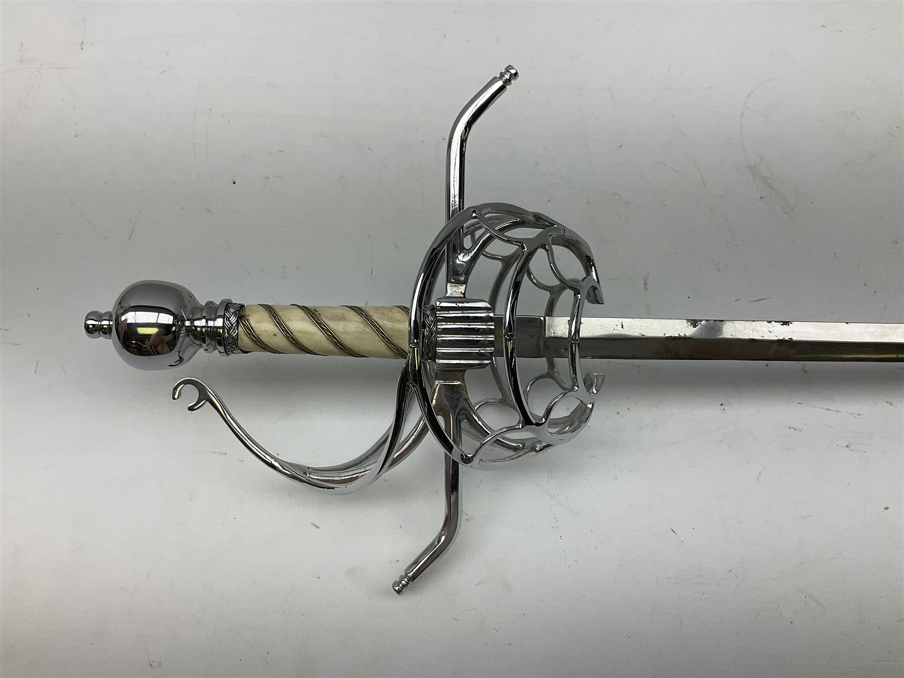 Replica knight's longsword, the 91.5cm double-edged steel blade with basket hilt and wire-bound bone grip with spherical pommel, in leather scabbard L112cm overall