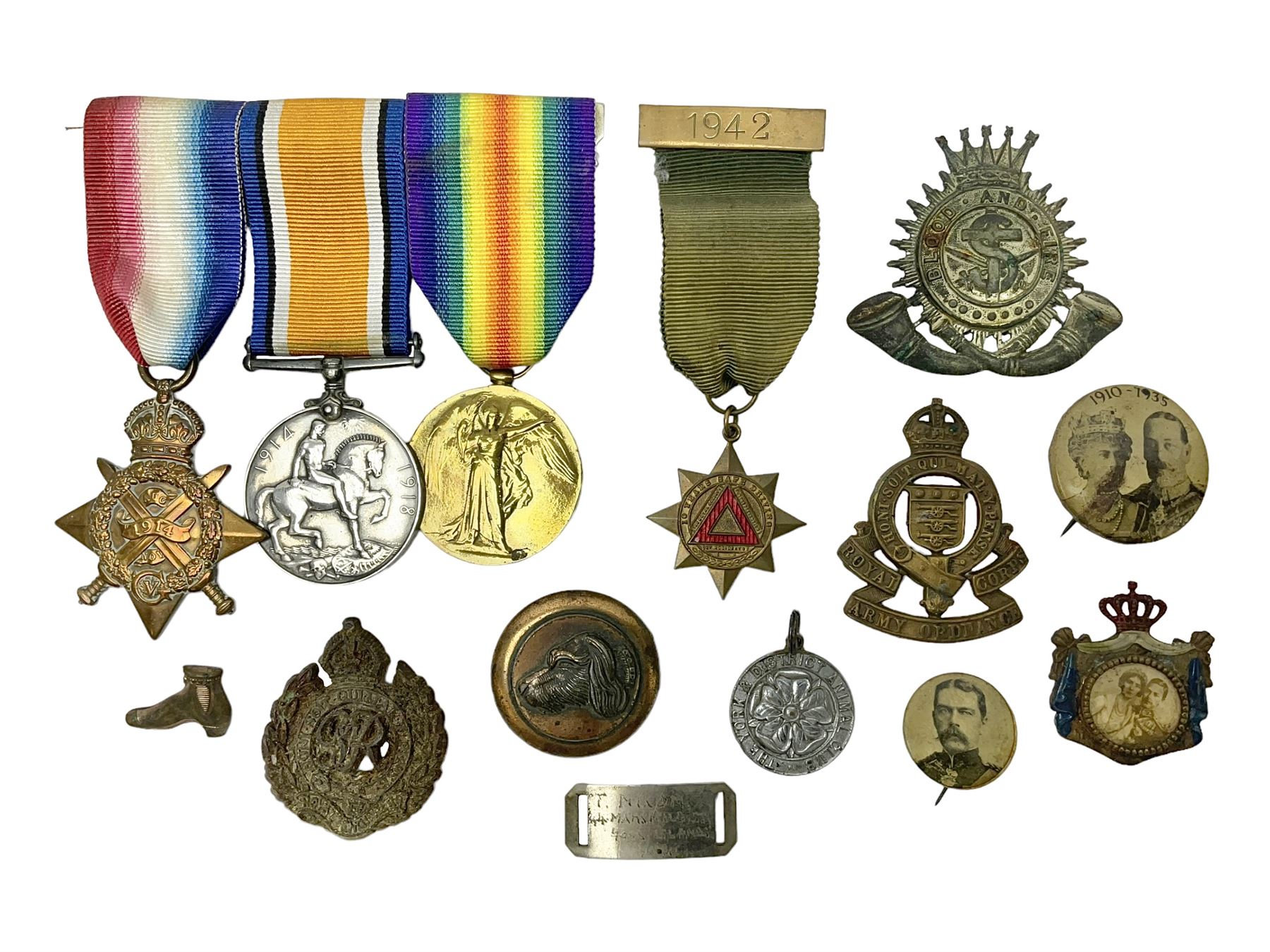 Made-up group of three WWI medals comprising 1914 Star awarded to 23598 Gnr. F. Jefferson R.G.A., British War Medal and Victory Medal with names removed; with ribbons on wearing bar; 1942 Motorist's Medal and small quantity of cap badges, Royalty badges etc