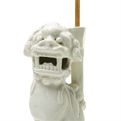 Pair of 19th century Chinese blanc de chine joss stick holders in the form of  Buddhist lions on rectangular bases H20cm (2)