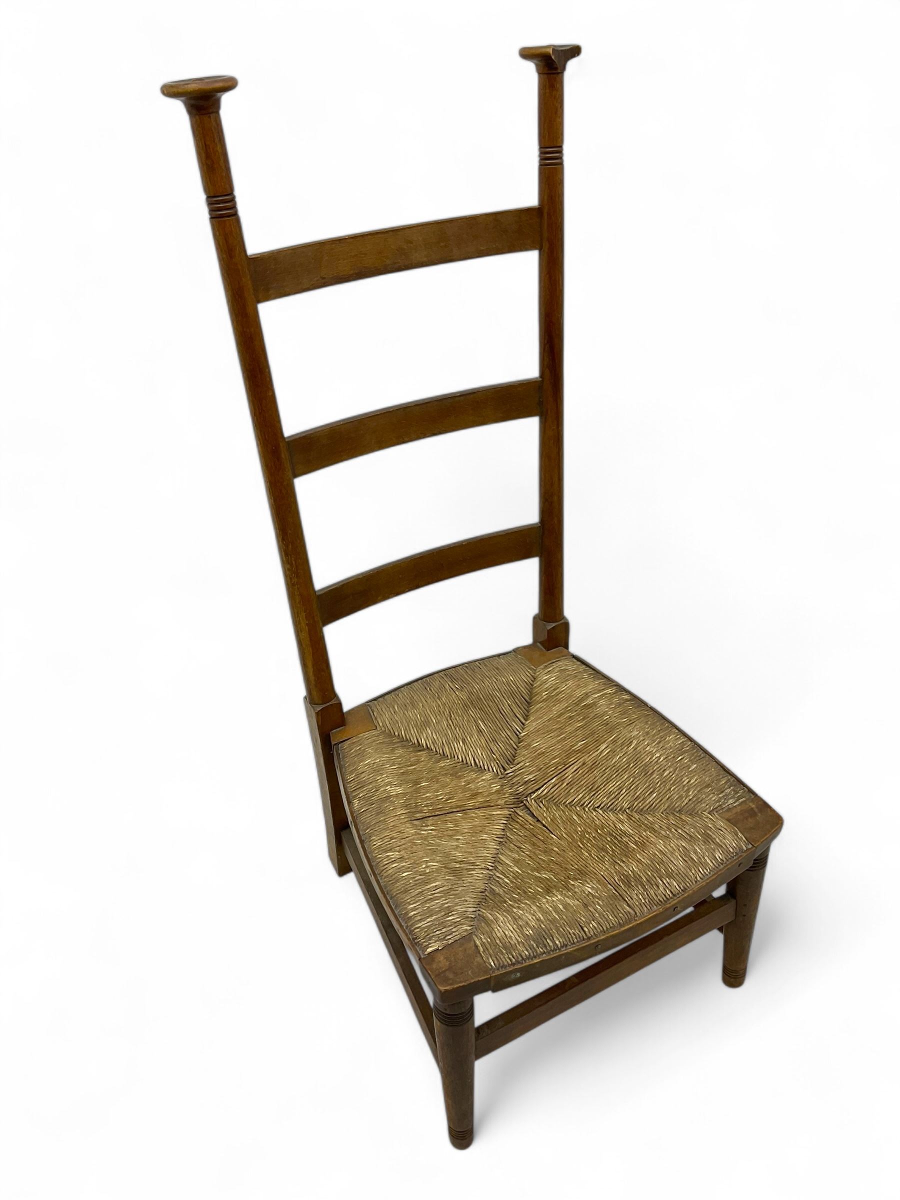 Attributed to William Birch of High Wycombe - Arts & Crafts oak ladder-back side chair, with turned finials, rush seat, and stretchers, raised on square-section supports; 19th century mahogany Pembroke table, rectangular drop-leaf top raised on turned supports with central stretcher and splayed feet