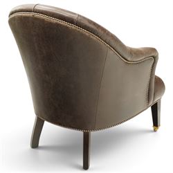Georgian design tub-shaped club armchair, upholstered in back-buttoned dark tan leather with sprung seat, raised on square tapering supports with brass cups and castors