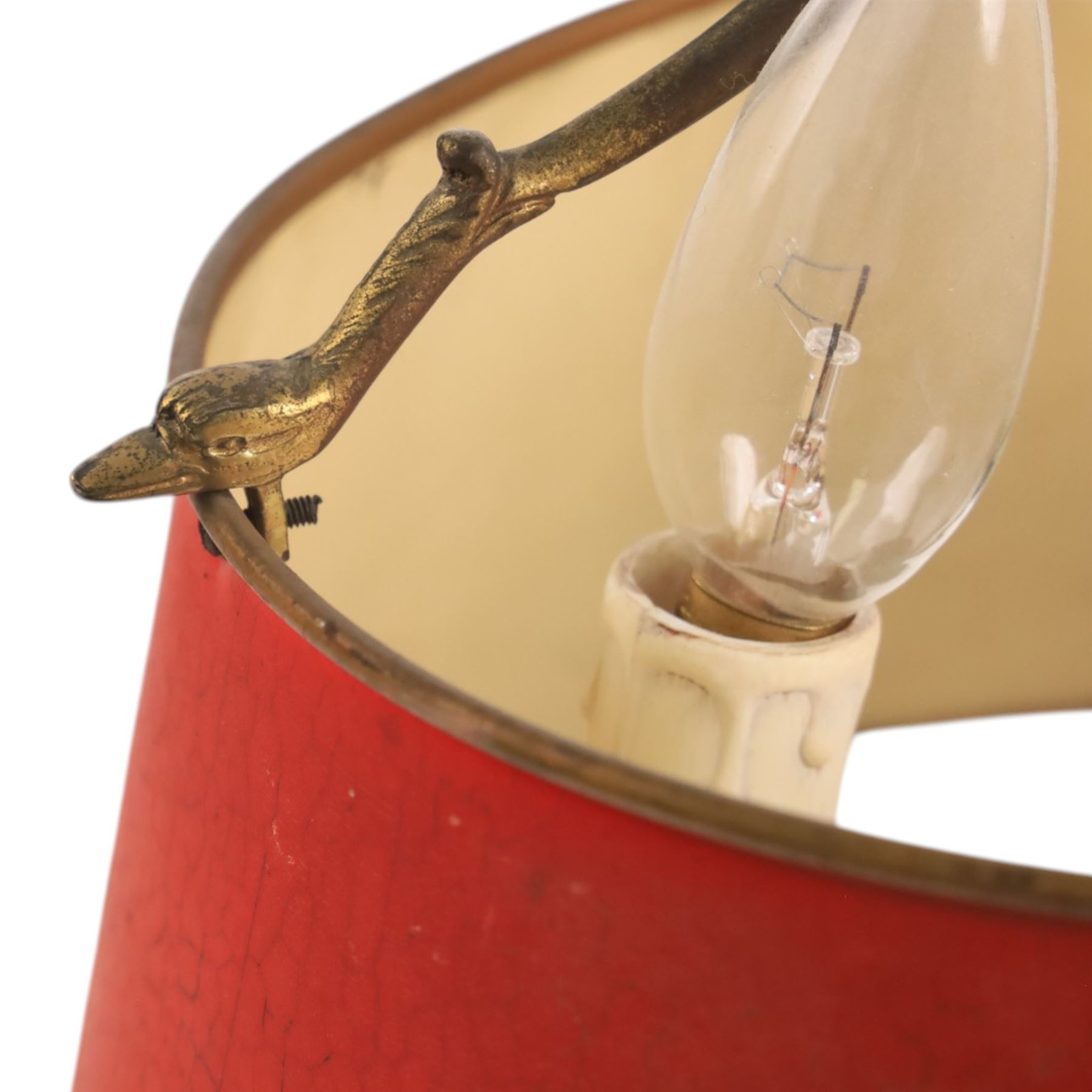 Bouillotte lamp, the adjustable red tole shade above three brass sconces upon a circular dished base, H54cm