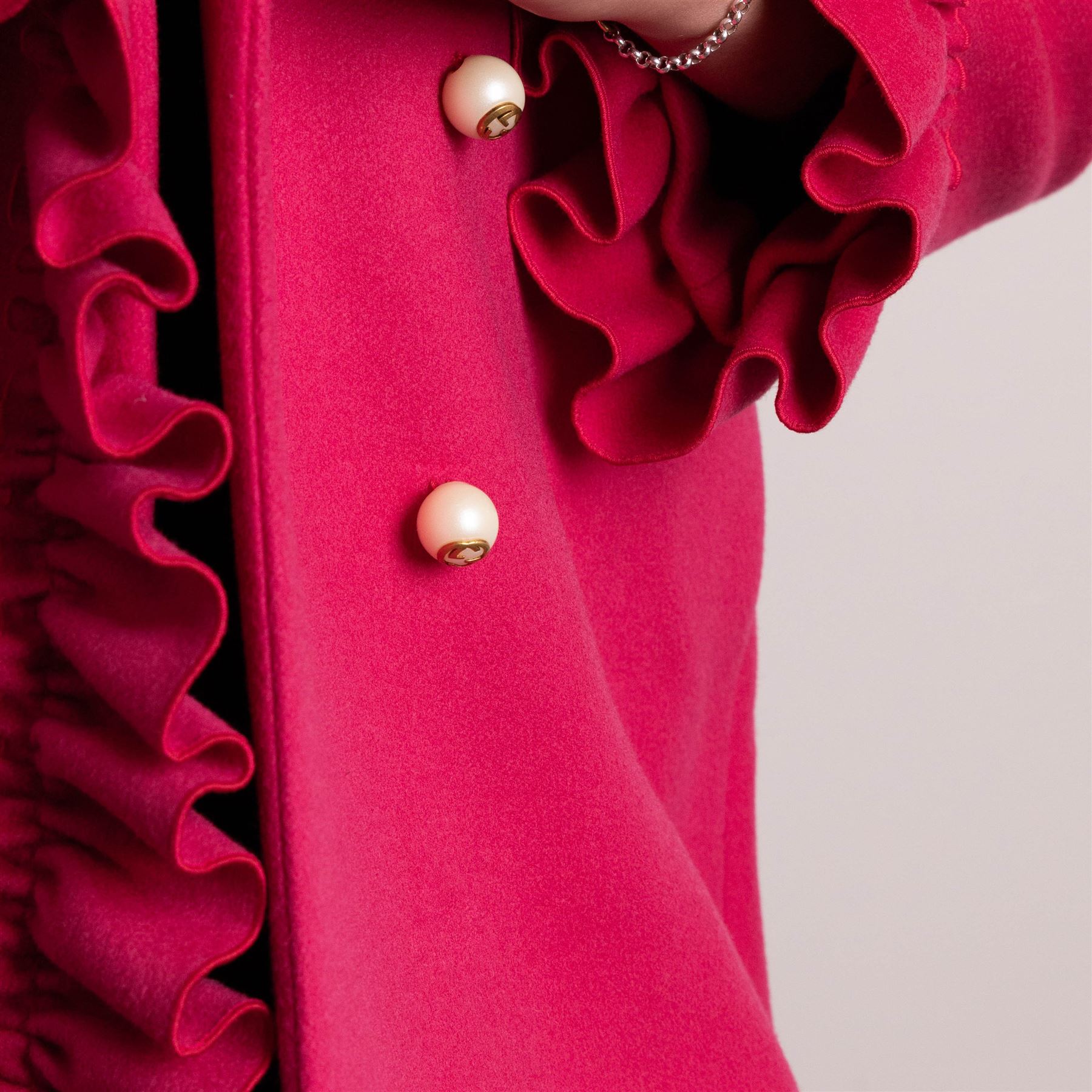 Gucci - wool ruffle-front single-breasted coat in bright fuchsia pink, with high ruffled collar, cascading ruffle trim to the front, collar and cuffs, faux pearl and gilt GG monogram logo button fastening, size 44, unused with the original garment bag and hanger