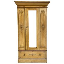 19th century painted pine wardrobe, the projecting cornice over mirror glazed door, with painted decoration depicting scrolling foliate and urns, drawer to base on skirt