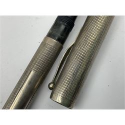 Three parker fountain pens, one example with 14ct gold plated cap and personal engraving, in Parker 51 box, together with a silver Sampson Mordan Everpoint propelling pencil with personal engraving and a silver cased fountain pen with 14ct gold nib and a souvenir bronze Dollfus-Mieg medallion, awarded to John G Sedorski, in fitted case 