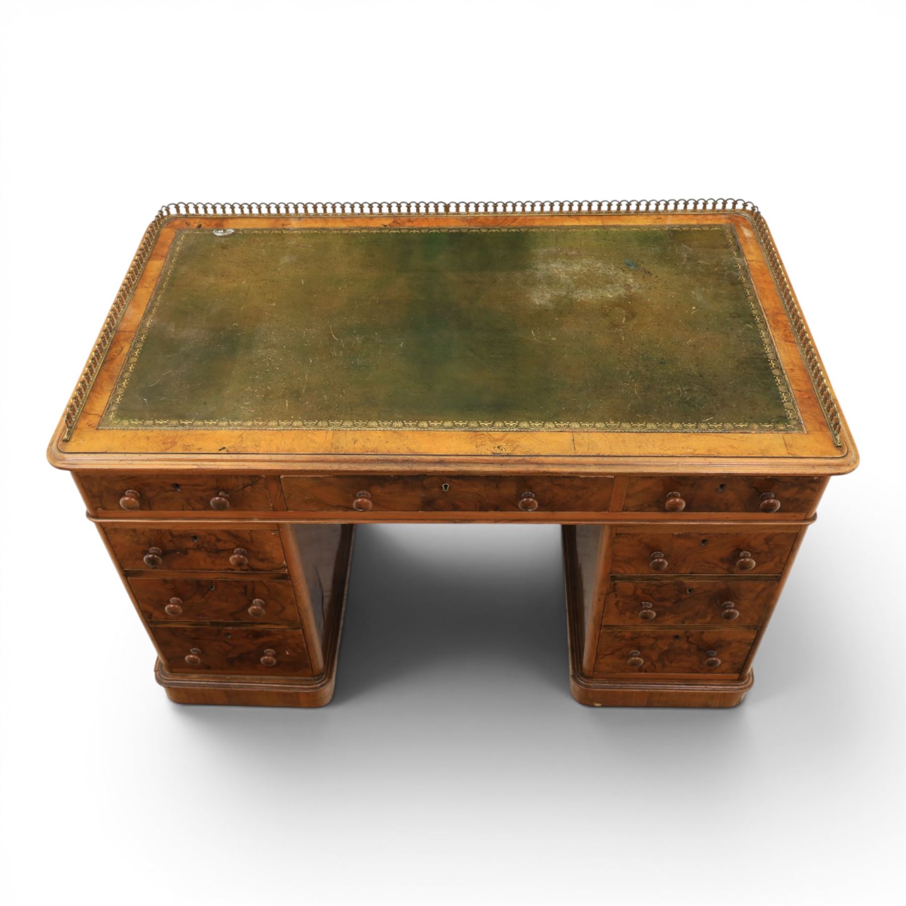 Victorian figured walnut twin pedestal desk, brass galleried top with inset tooled green leather writing surface, above three frieze drawers, raised on two pedestals with three drawers, on plinth bases above castors