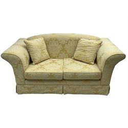 Two-seat hardwood framed sofa, traditional shape with arched cresting rail over rolled arms, upholstered in pale gold and cream damask fabric with repeating foliate pattern