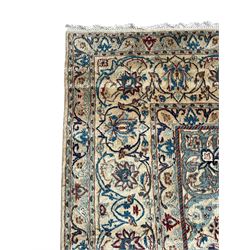 Persian Nain blue and ivory ground rug, wool with silk inlay, overall arabesque design, central medallion surrounded by interlacing and scrolled leafy branches and palmettes, the scrolling border decorated with stylised plant motifs, within guard stripes