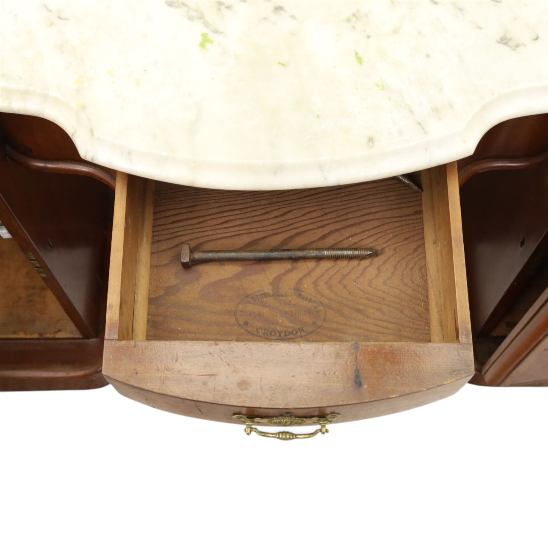 Victorian mahogany pedestal dressing table, shaped white marble top over central frieze drawer, flanked by two pedestal cupboards with four dummy drawer fronts and ornate brass handles, recessed kneehole with platform base, on plinth supports