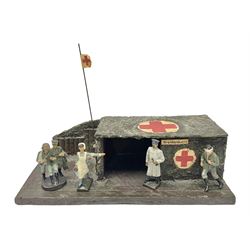 German Lineol playset of a camouflaged Field Hospital with flag and four figures of staff and casualties L30cm