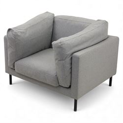 Modern snuggler armchair, upholstered in grey fabric, box-shaped frame with loose back and side cushions, raised on slender black metal legs