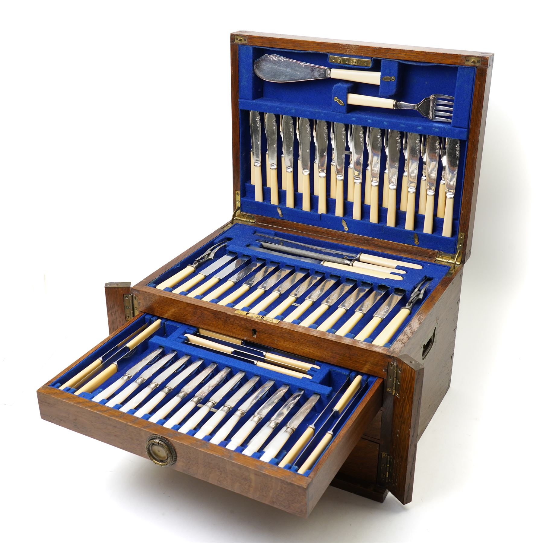 Suite of plated table cutlery for twelve covers including fish cutlery and servers, fruit knives and forks with mother of pearl handles, bone handled knives, carvers etc in an oak  three drawer cabinet with hinged lid W47cm 160 pieces