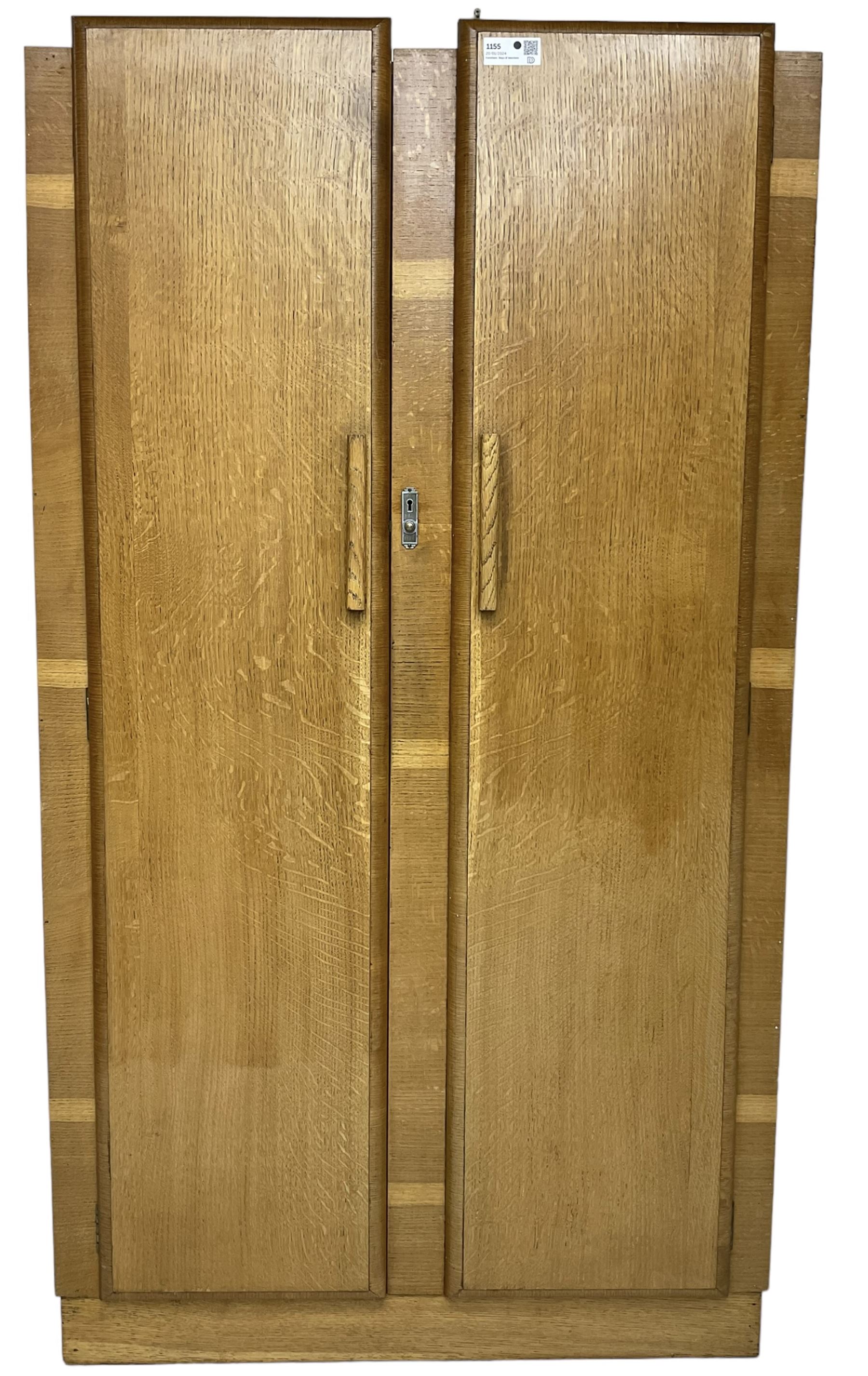Early 20th century Art Deco period oak Gentleman's wardrobe, the interior fitted with shelves, hanging rails and two long drawers