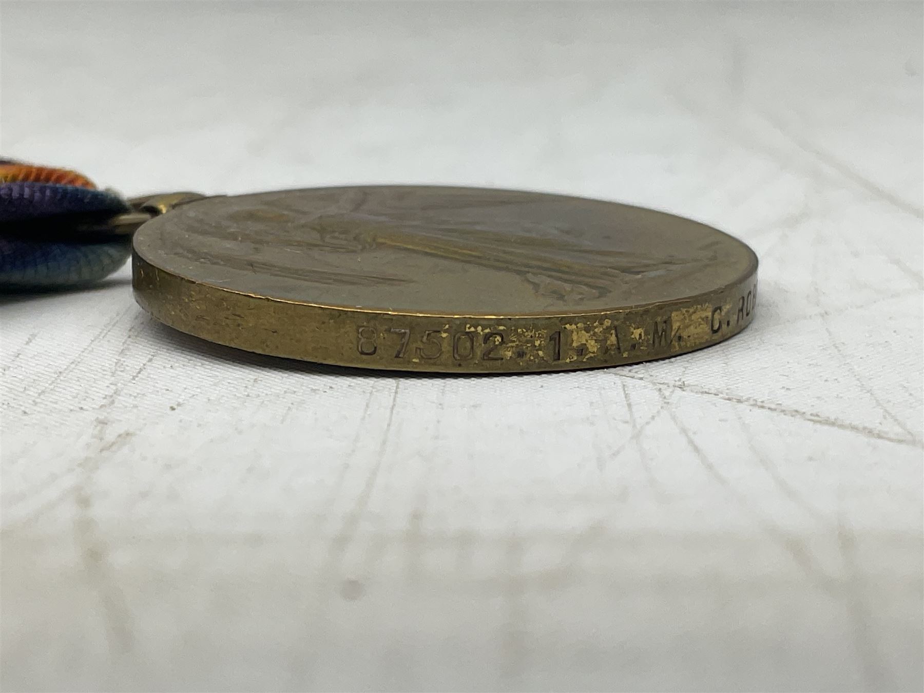 Three WW1 medals comprising 1914-15 Star awarded to 58648 Spr. C. Roberts R.E.; British War Medal and Victory Medal awarded to 87502 1.A.M. C. Roberts R.F.C.; and REME cap badge (4)