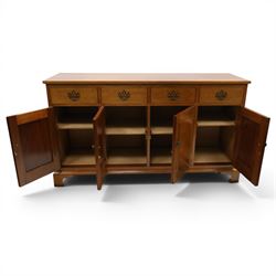 Acornman - mahogany sideboard, rectangular top over four drawers and four panelled cupboard doors with brass handles, on bracket feet, with signature carved acorn, by the workshop of Alan Grainger of Brandsby