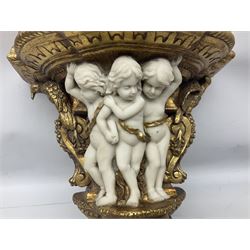 Composite gilded wall bracket shelf, ornately moulded with three putti figures, L42cm