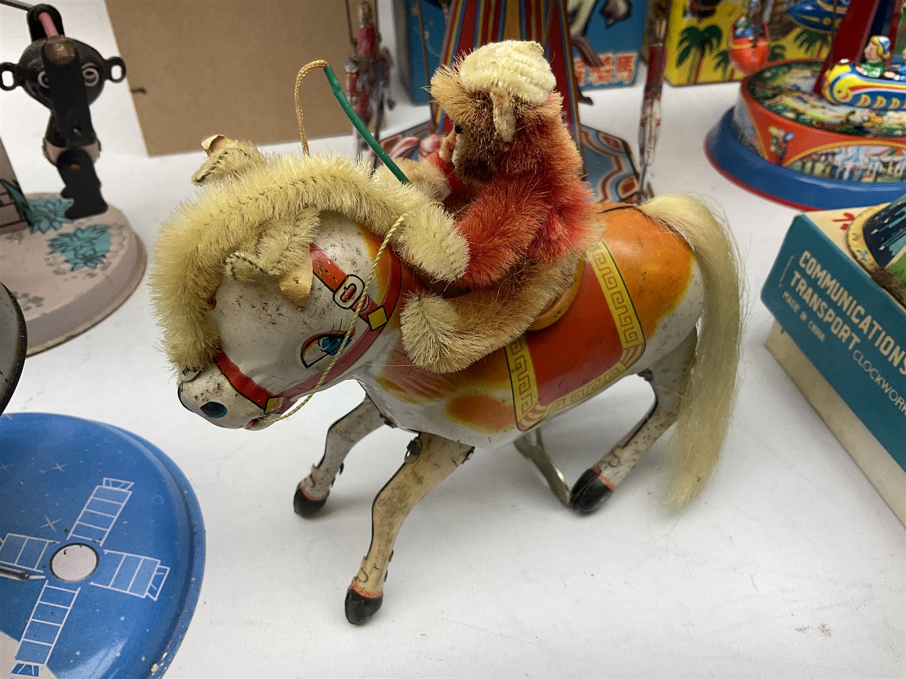 Mid 20th century and later tin plate clockwork toys, to include merry-go-rounds, spaceship carousel, walking robot, Schylling airport control tower, monkey riding horse, astronaut space station etc, including German and Japanese examples, some with boxes (12)