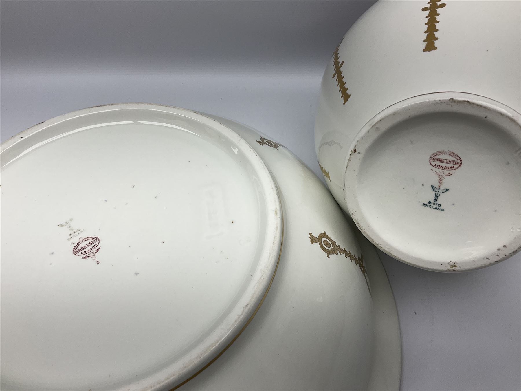 Early 20th century Bishop and Stonier four piece toilet set, comprising washbowl, wash jug, toothbrush pot, and chamber pot, each  decorated with deep blue band and husk swags and festoons in gilt, with printed Caduceus Bisto marks beneath and printed retailers mark 'Manufactured for Harrods Limited London', wash bowl D43cm, wash jug H31.5cm