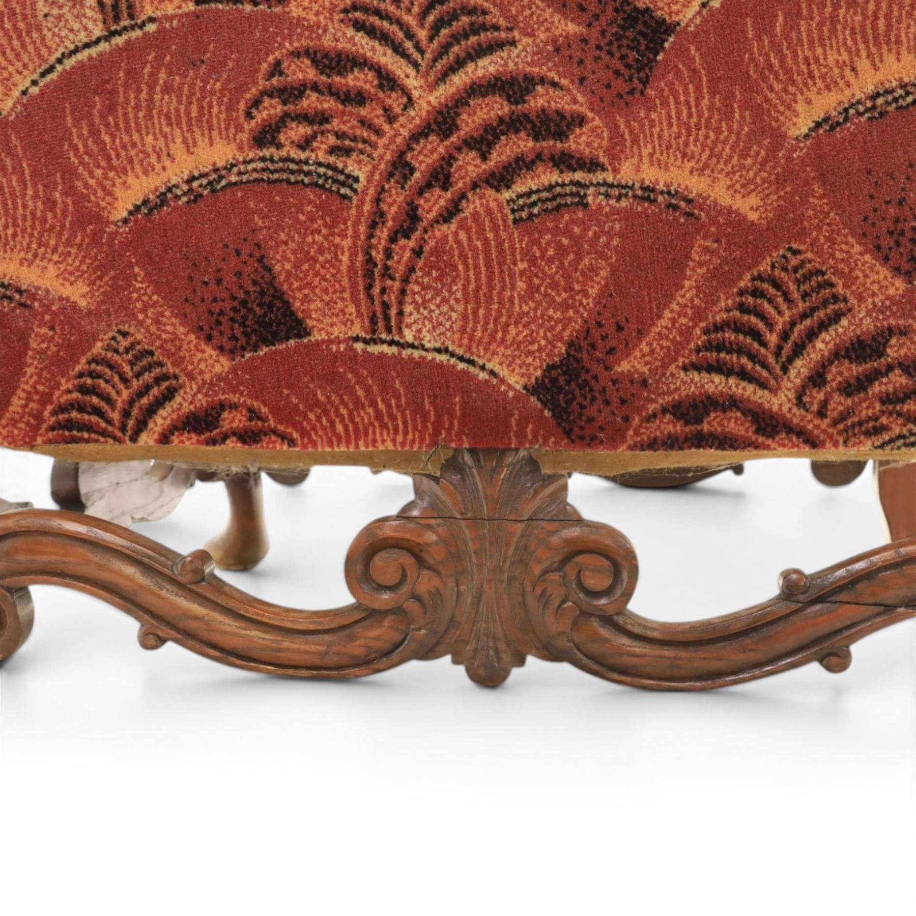 Large upholstered wingback chair, crimson geometric upholstery, carved front apron raised on cabriole supports 