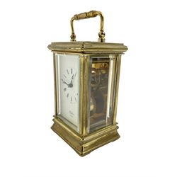 English - 20th century 8-day carriage clock, in a brass case with a white enamel dial, Roman numerals, minute track and steel moon hands, dial signed 