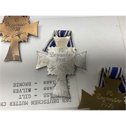 WWII set of three German Mother's Crosses, 1st Class in gilt, 2nd Class in silver and 3rd Class in bronze; all with ribbons (3)
