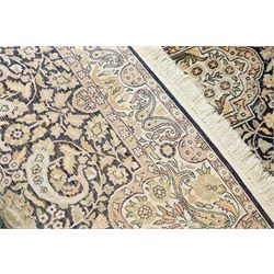Persian style rug, central medallion with symmetrical floral arabesques, complex and layered borders featuring flowers and scrolling vinework