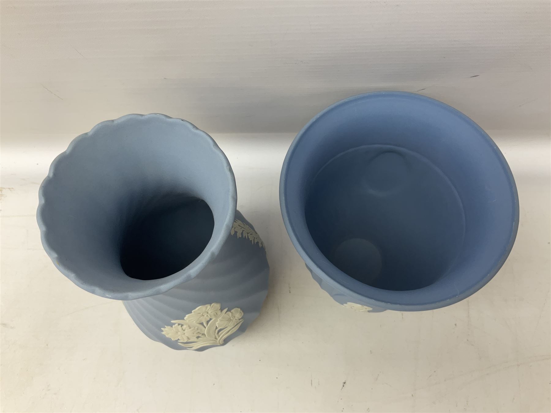 Wedgwood pale blue Jasperware, to include a pair of tulip vases, large vase with fluted rim, trinket dishes, trinket box etc, together with Wedgwood miniature hanging decoration in the form of a tea set 