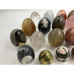 Collection of twenty-one hardstone specimen eggs, including labradorite, calcite, orbicular jasper, tiger's eye, smokey quartz, fossilised wood etc, originally part of the collection of the late Stanley J Seeger
