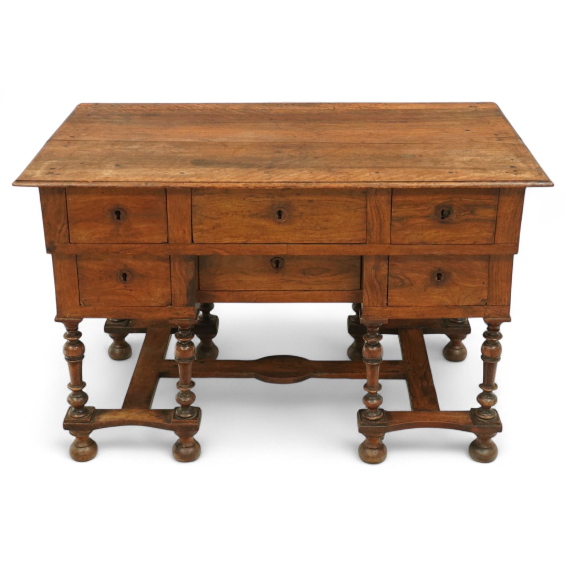 19th-century Louis XIV design French walnut bureau Mazarin, rectangular top above central drawer and recessed drawer flanked by two rows of small drawers,  supported on baluster turned legs united by an H-form stretcher, raised on bun feet 