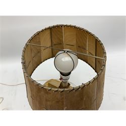 Mid 20th century Paul Caron carved table lamp, modelled as man standing before an oven, the chimney supporting the panelled shade, the base signed P.E. Caron, H42cm