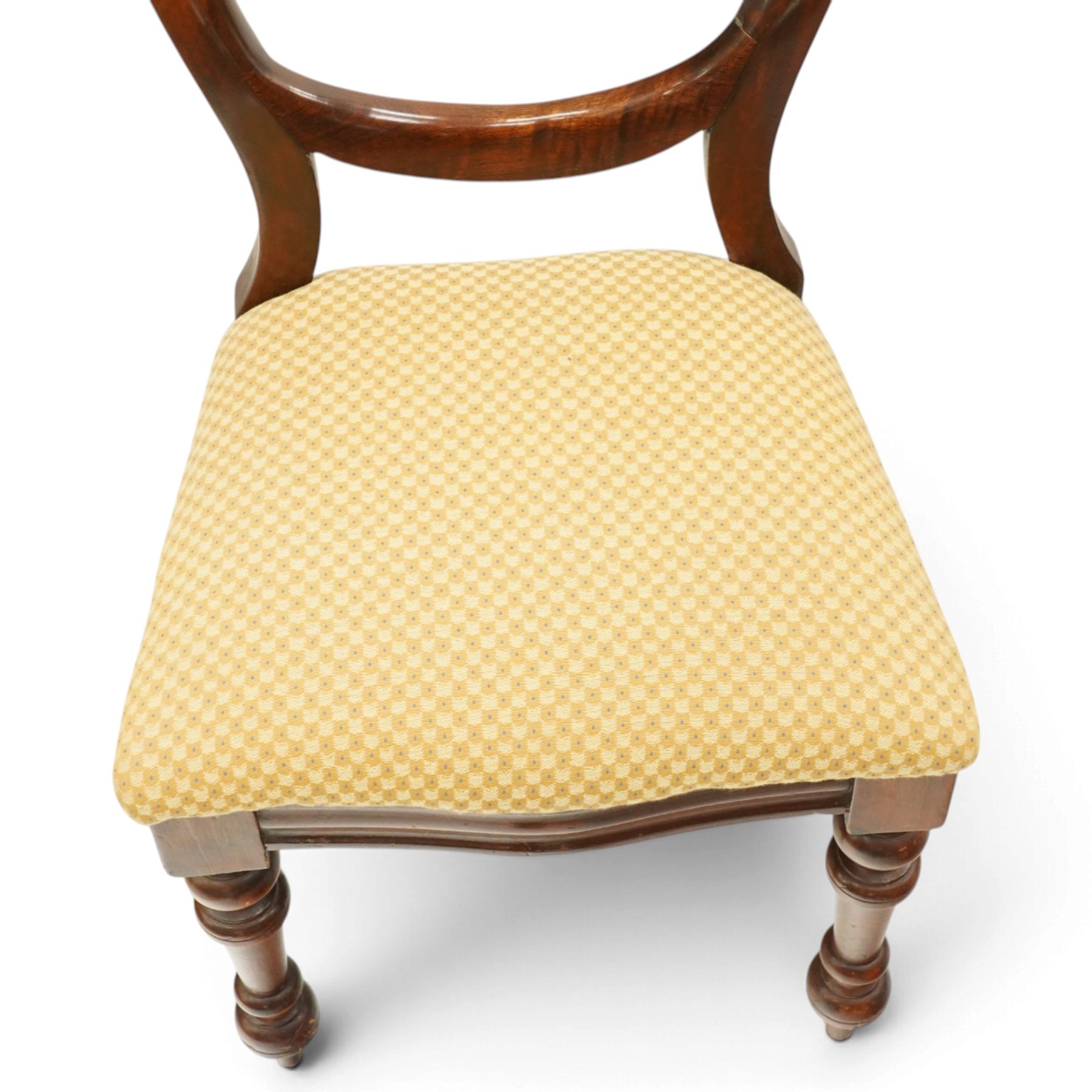 Set of eight mahogany balloon-back dining chairs, drop-in seats upholstered in yellow patterned fabric, raised on turned-front and rear-splayed supports