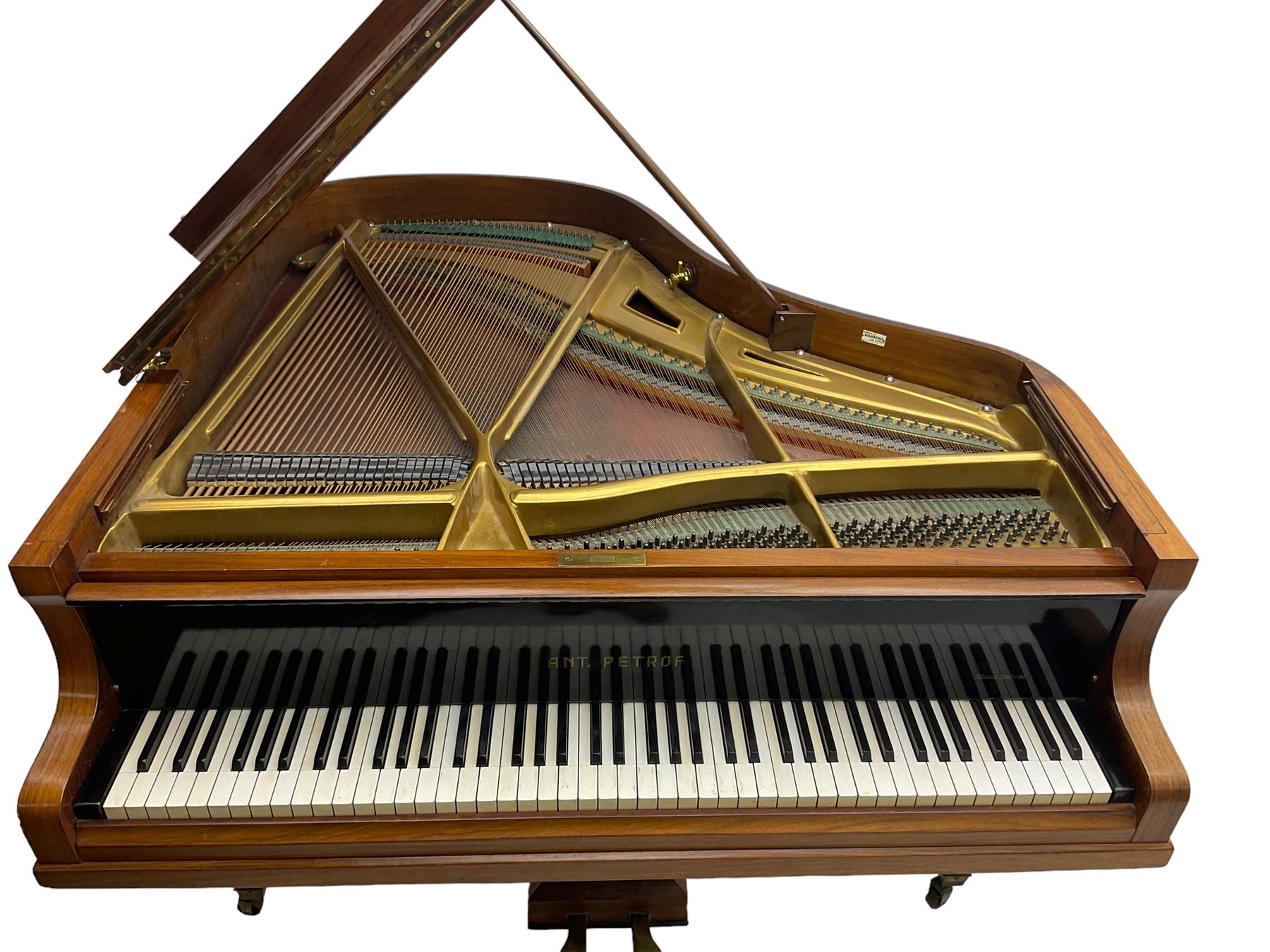  Antonin Petrof - Walnut overstrung baby grand piano, 7 0catve 85 key compass with original strings, tuning pins, damper felts and hammer heads, with roller keyboard action and iron frame, sustaining and una-corda pedals, sliding open lattice music desk, supported on square tapering legs with brass cups and castors, with inner ebonised key fall and ivorine label inscribed 'Supplied by Harrods, London'.