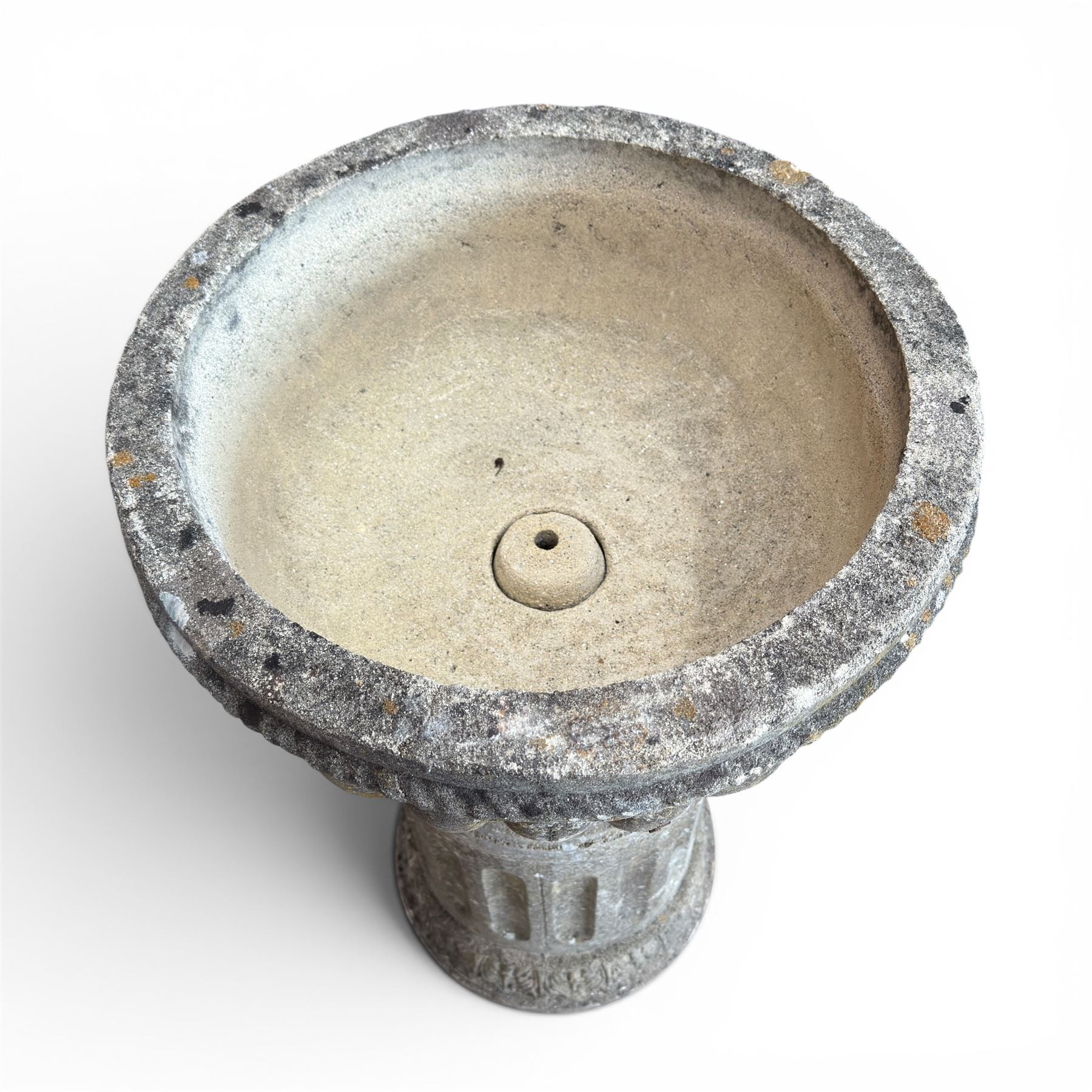 20th century good quality weathered cast stone pedestal urn of ecclesiastical design, circular lobed bowl with rope twist and lattice border, raised on squat base with fluted column  and acanthus decorated base