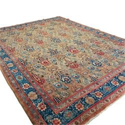 Central-Western Persian Sarouk hand-knotted carpet, beige ground, with an all-over design of boteh and floral sprays in red and blue within a floral border on blue ground 