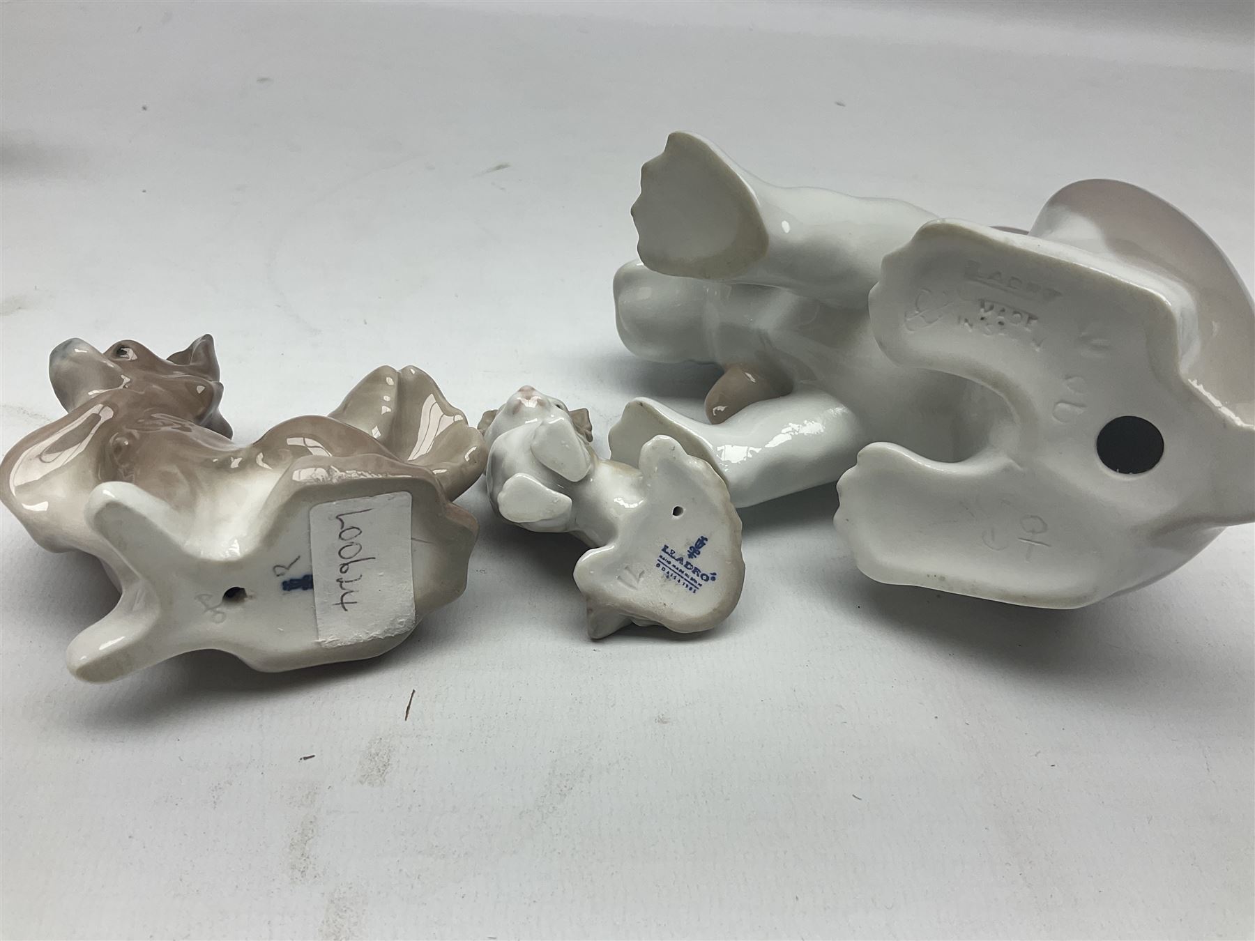 Lladro figures of animals, comprising Mini Lion no 5436, Beautiful Burro no 5683, Hawk Owl no 5422, Beagle Puppy Sitting no 1071, Duck Flying no 1264, Miniature Cat no 5308 and Small Papillon Dog no 4749, four with original boxes, largest example H14cm