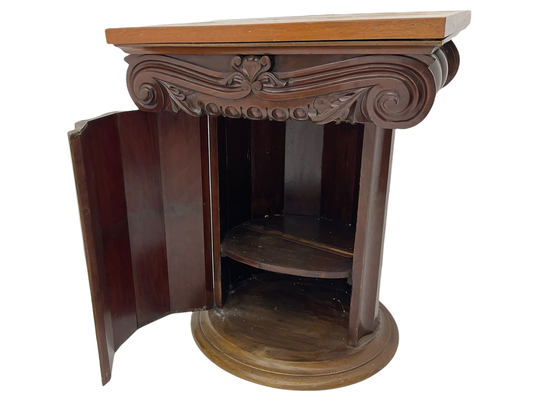 Victorian mahogany vanity unit in the form of a column, the scrolled top with hinged lid revealing mirror, wash bowl and toiletry dishes, on scalloped cylinder pedestal with single door, the interior fitted with shelf