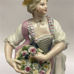Pair of late 19th/early 20th Century Meissen figures, modelled as flower sellers, after the original by Michel Victor Acier, she holding basket of flowers, he holding flowers in his hat, each with underglaze cross swords mark beneath, tallest H16.5cm