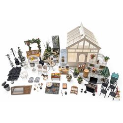 1:12 scale dolls house conservatory and garden accessories, including white wooden glazed conservatory on a stone effect base, black and white metal garden seating, barbecue, plant shelves, parasol, barbeque accessories, large planters, rabbit hutch, animals, chimenea, etc