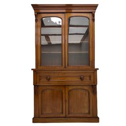 Victorian mahogany bookcase on secretaire, the stepped moulded cornice over two glazed doors enclosing three shelves, fall front secretaire drawer with fitted interior, double panelled cupboard below, plinth base
