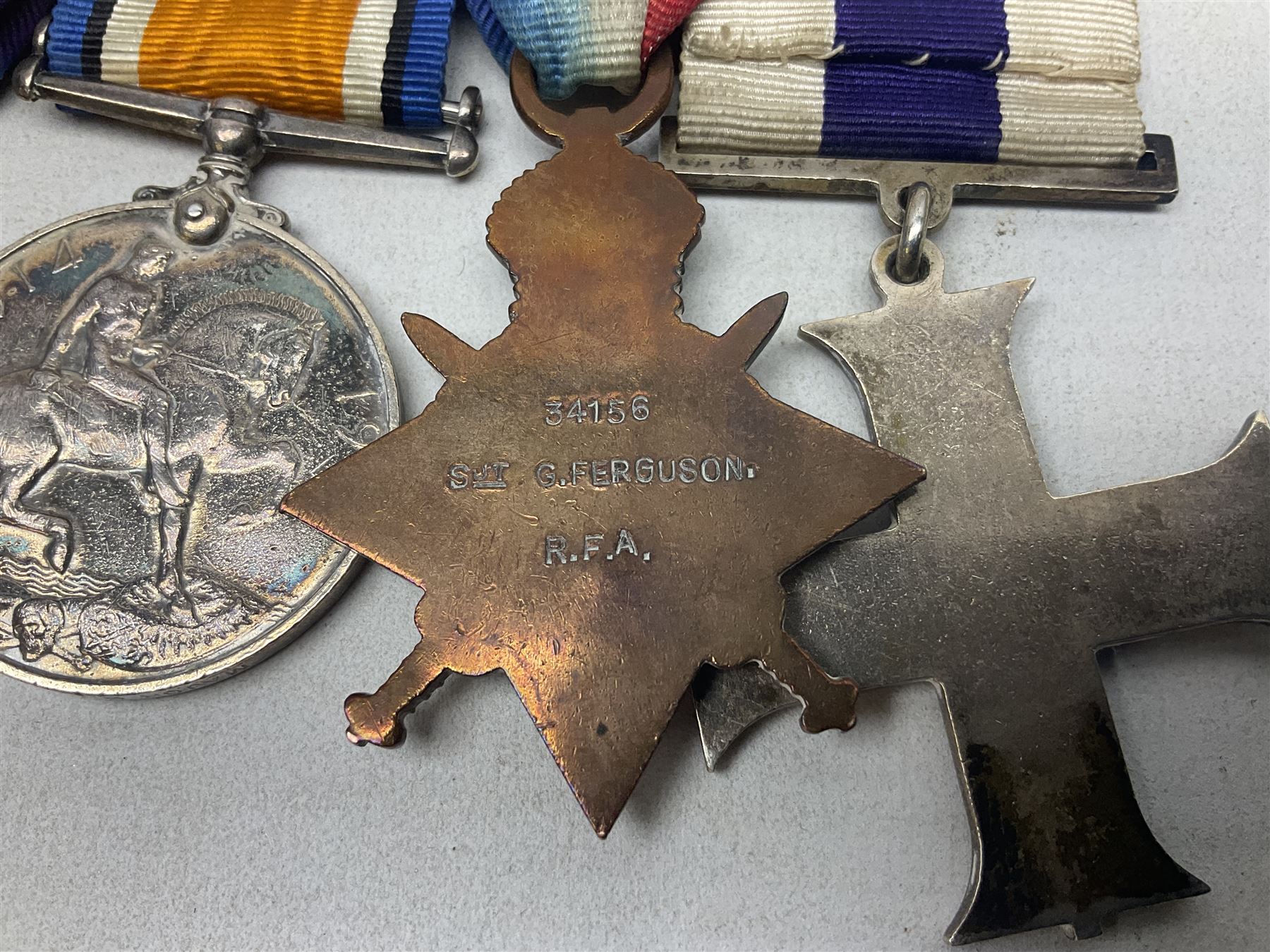 WW1/WW2 Military Cross group of five medals comprising M.C., 1914 Star with date clasp to 34156 Sjt. G. Ferguson R.F.A., British War Medal and Victory Medal with MID leaves to Major G. Ferguson, WW1 French Croix De Guerre with MID Star and WW2 Defence Medal; all with ribbons on pinned wearing bar; WW1 group of five miniature dress medals; two Royal West Kent cap badges; early 20th century silver cigarette case engraved with GF monogram and adapted as a photograph holder with image of Ferguson in civilian clothing; presentation Rotary 9ct gold cased wrist-watch with 1931 British Legion inscription verso; and archive of ephemera including 1914 MID certificate; WW2 Home Guard certificate; over twenty career spanning photographs of Regimental groups, portraits, Sandhurst etc; 1914 Commission document to 2nd Lieutenant; 11th Brigade R.F.A. Roll of Honour 1914-18; 'Soldier's Small Book'; Army Book 439 etc