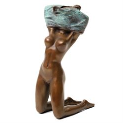 Bronze figure of a kneeling nude removing her shirt, signed 'Milo', H17cm