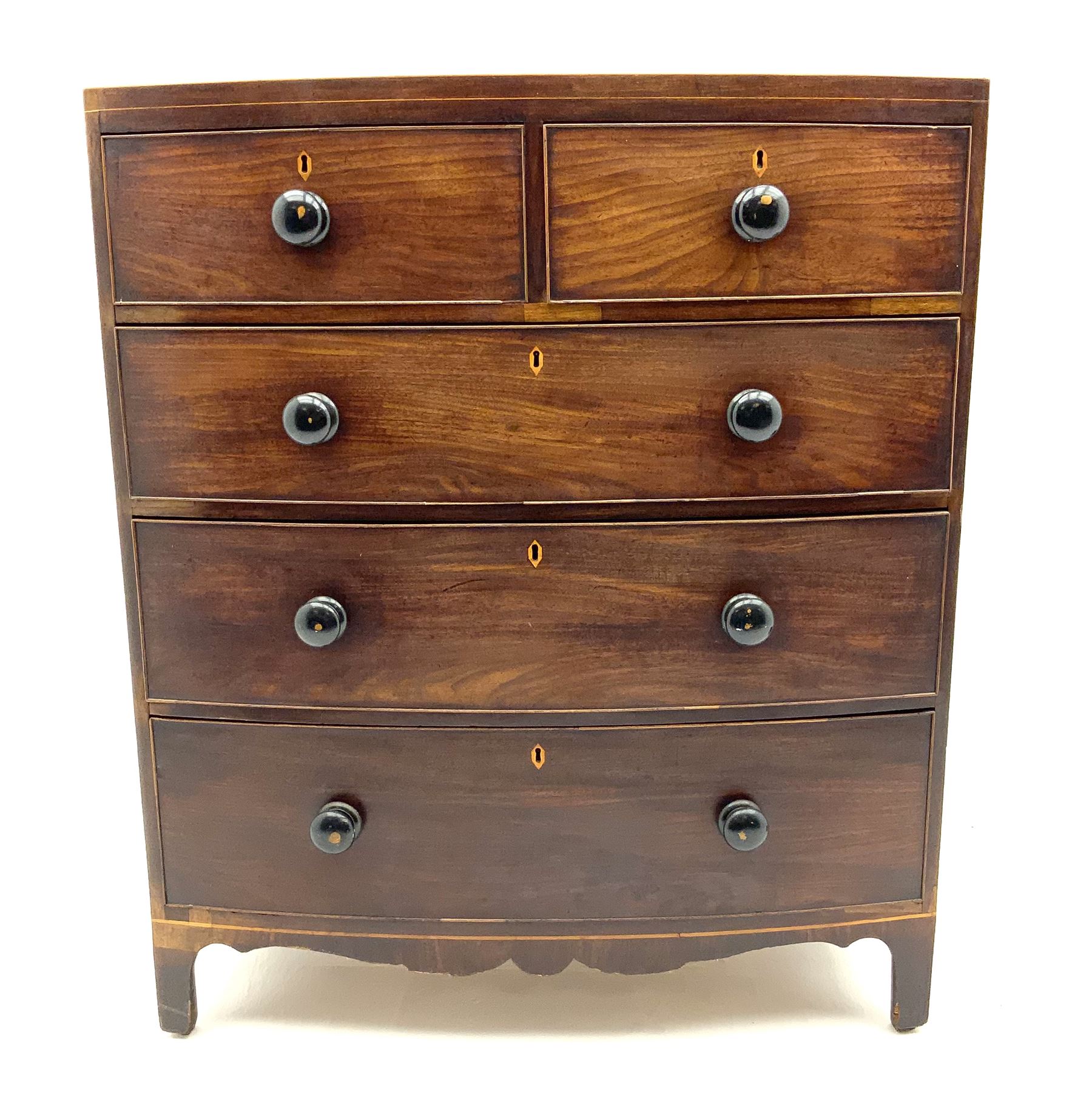 Early 19th century mahogany bow front chest, fitted with two short and