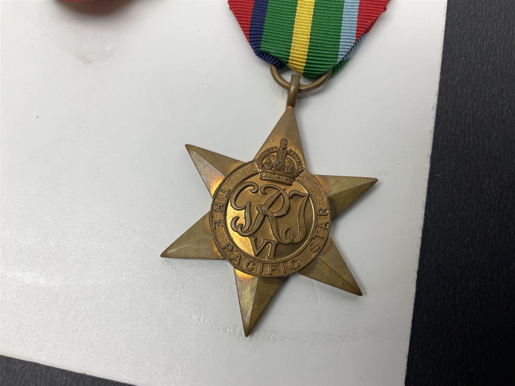 Representative display of WWII Campaign stars comprising 1939-1945 Star, Atlantic Star, Air-Crew Europe Star, Africa Star and Pacific Star; together with the corresponding group of miniatures; all with ribbons