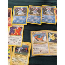 Collection of Pokemon TGC trading cards, including two WB First Movie Black Star promo cards Pikachu no. 4 and Dragonite no. 5, two Ancient Mew Black Star holo promo cards, Gym Challenge Giovanni's Persian 8/132 holo and a small collection WOTC, Neo Discovery and Neo Genesis cards, together with thirty four Bandai Carddass Pokemon cards, including prism Charizard no. 186 and Pokemon Topps cards including holo examples 