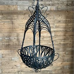 Pair of black finish wrought metal hanging baskets, with brackets