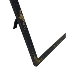 Early 20th century Chinoiserie black lacquered mirror, of rectangular form with rounded upper corners, painted in gilt with traditional landscapes, with easel style support verso 
