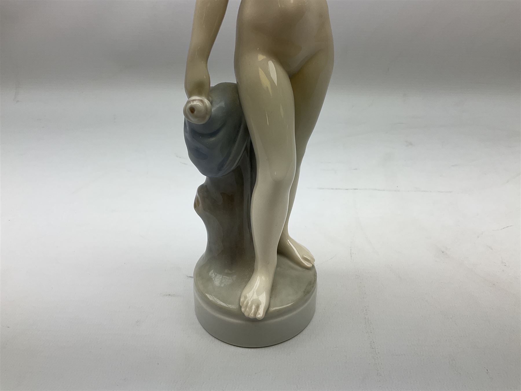 Royal Copenhagen 'Helena' figure modelled as a nude girl holding hand mirror, designed by Hans Hansen, model no. 4639, with printed and painted marks beneath, H25.5cm
